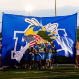 The Fort Mill football team runs onto the field for the Catawba Ridge matchup.