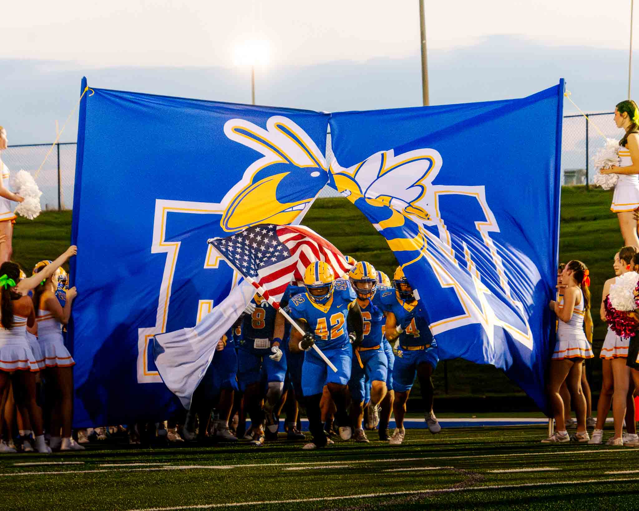 The Fort Mill football team runs onto the field for the Catawba Ridge matchup.