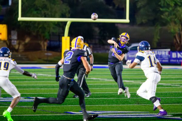 Yellow Jacket quarterback Quinn Kelly throws a short yardage pass to wide receiver Gray Patterson.